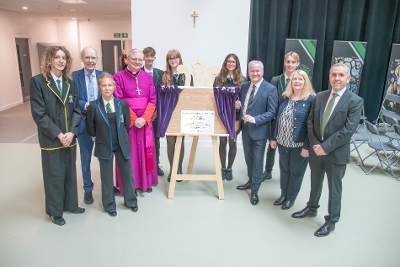 Pupils staff and invited guests with the official plaque to open the school 